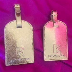 Two gold Elton John bag tags . New and never used. Adjusting strap .